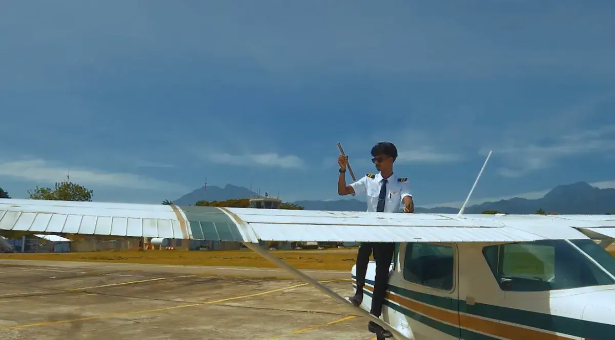 A cadet on the wing of a Cessna trainer at the airfield