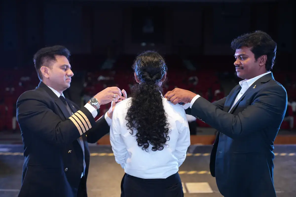 Instructors pinning epaulettes on a Lycoming cadet